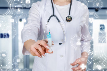 Fototapeta premium A doctor holding a syringe with some substance.