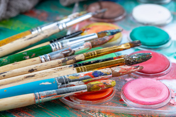 Paint brushes and paints for drawing.