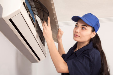 woman technician repair air conditioner