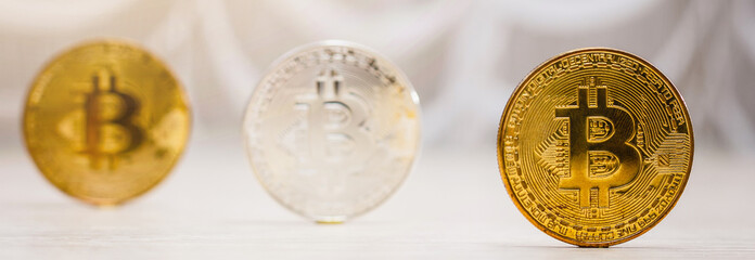 Cryptocurrency physical colored bitcoin coins  blue  and yellow