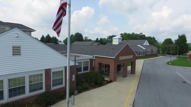 Aerial view of a school bulding with an american flag.