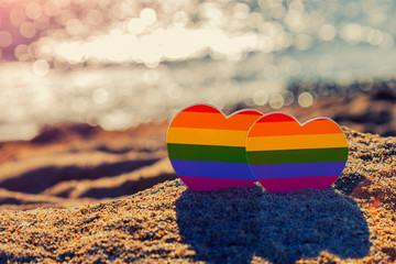 Hearts on the sand, symbol of same-sex love. Gay marriage, romantic LGBT journey to the sea