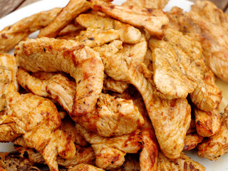 A pile of grilled poultry meat slices (turkey).
