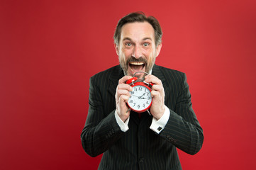 How much time left till deadline. Manager with alarm clock. Man bearded businessman hold clock....