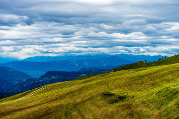 Alpe di Siusi, Seiser Alm with Sassolungo Langkofel Dolomite, a view of a grassy hill