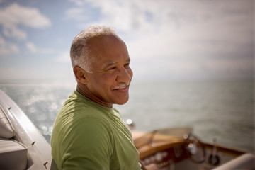 Mature adult man sitting on a boat.