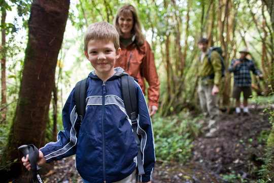Young boy happy to be hiking with his family 