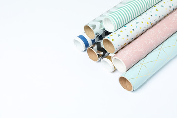 Rolls of festive wrapping paper on white background. Space for text