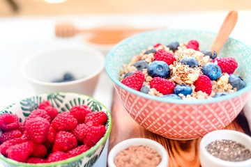 High protein healthy breakfast, buckwheat porridge with blueberries, raspberries, flax seeds and honey Closeup view, selective focus