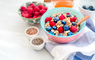 High protein healthy breakfast, buckwheat porridge with blueberries, raspberries, flax seeds and honey Closeup view, selective focus