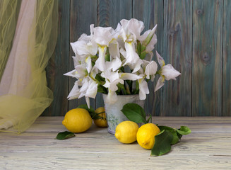 Lemons and irises in a vase close-up