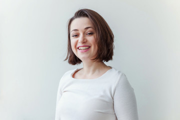Happy girl smiling. Beauty portrait young happy positive laughing brunette woman on white background isolated. European woman. Positive human emotion facial expression body language