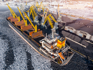 Industrial photo, Loading coal mining in port ship with crane. Aerial top view