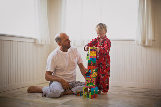 Father and son building a tower of blocks
