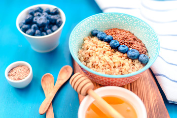 Buckwheat porridge in a bowl with flax seeds and blueberries. oncept healthy food, detox, diet, breakfast