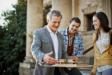 Architect discussing first home with young couple.