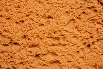 Orange Hauswand mit Rauhputzverkleidung