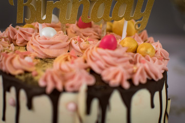 Detail of a luxury hand made cake with a partial close up of a written