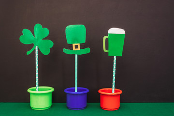 cut out of colored cardboard toy clover, hat, glass