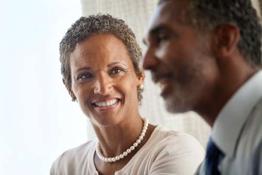 Smiling woman looking at a male colleague.