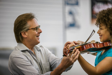 Teenage girl learning to play violin.