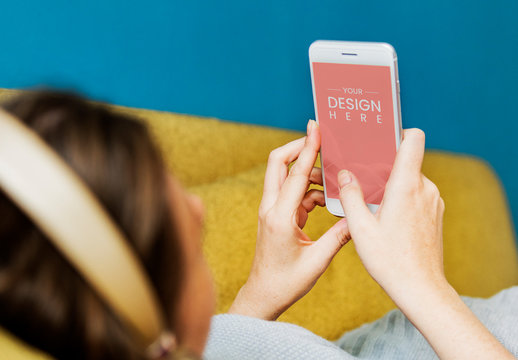 User with Smartphone on Couch Mockup