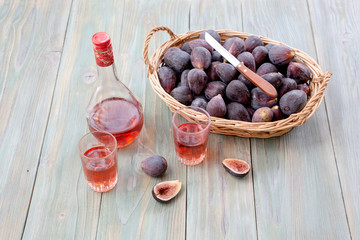Figs in a basket and glasses of wine