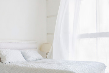 White bedroom minimal interior with white bed, big window with white curtains