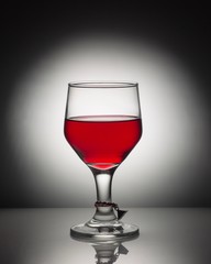 glass of red wine on black background