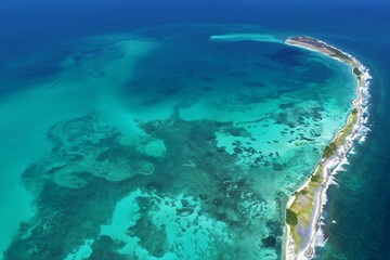 Caribbean sea, Los Roques, Venezuela: vacation on the blue sea and paradisiac beach. Vacation travel. Travel destination. Tropical travel. Great beach scenery. Beautiful landscape.
