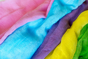 Textured background of several colored fabrics.