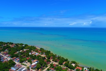 Aerial view of Cumuruxatiba Beach, Prado, Bahia, Brazil. Great landscape. Beautiful beach and river sceneries. Tropical travel. Travel Destination. Vacation travel. Nature scenery.