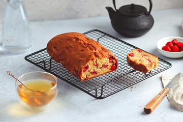 Fresh moist homemade delicious raspberry cake on black cooling rack
