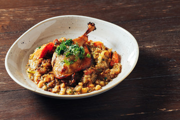 duck confit with lentils. restaurant meal