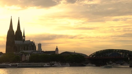 4K video clip of sunset behind Cologne Cathedral and trains on Hohenzollern Bridge above the River Rhine, Germany