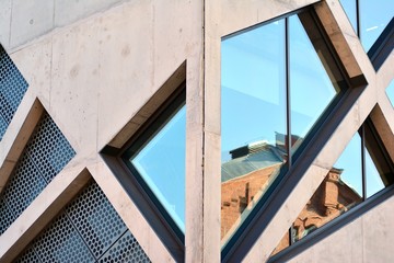 Abstract image of looking up at modern glass and concrete building. Architectural exterior detail of office building. 
