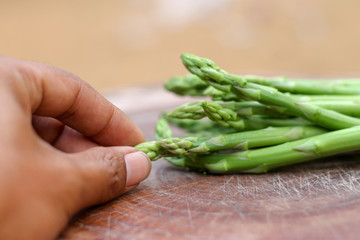 Man hand holding a bunch of fresh asparagus