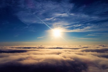 Naklejka na ściany i meble Sun above clouds with a blue sky. Fantastic landscape. Peace, Freedom, overcoming, inspirational, God. Great sky view! Drone flying above clouds. Sunrise view. 