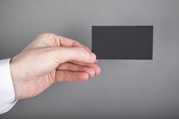 Fototapeta premium A man holding black business card