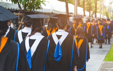 Education theme concept. Back view of Graduates during commencement.