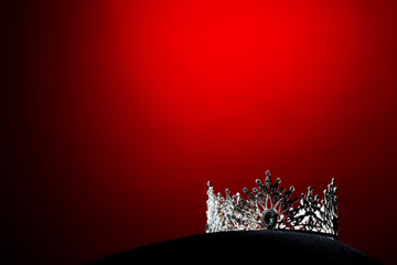 Silver Diamond Crown of Miss Pageant Beauty Universe World Contest sparkle light on black pillow, ready for wear Most beautiful Winner, studio lighting super red gradient background dramatic © Jade