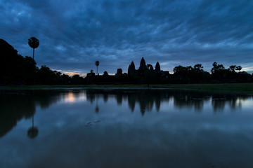 Angkor Wat reflected in the lake at sunrise, view of popular tourist attraction ancient temple in Siem Reap, Cambodia
