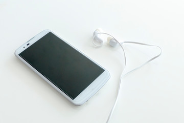 Modern White Smartphone with Headphones isolated on a White Background