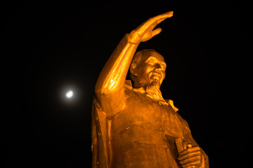 Bronze statue of President Ho Chi Minh and the moon on the background. Vietnam