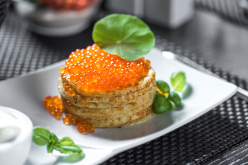 Pancakes with caviar in 
