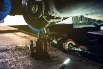 Close up on Mechanics repairing car wheels in the garage