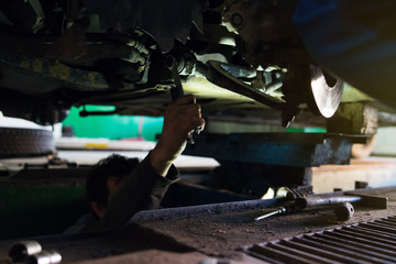 Close up on Mechanics repairing car wheels in the garage