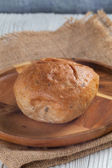 close up of white bread bun on plate