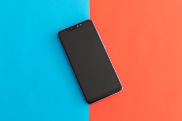 Isolated Black Smartphone on a Red and Blue Background