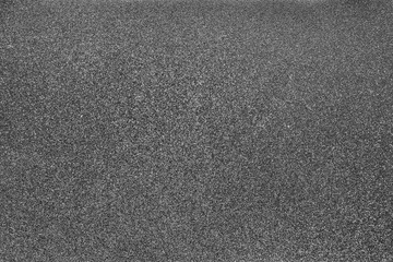 Closeup of dark gray matte metal texture. Shiny metallic surface.